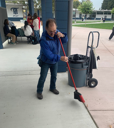 Charles Green sweeping the floor during the morning break (Photo By: Anthony Mindling).
